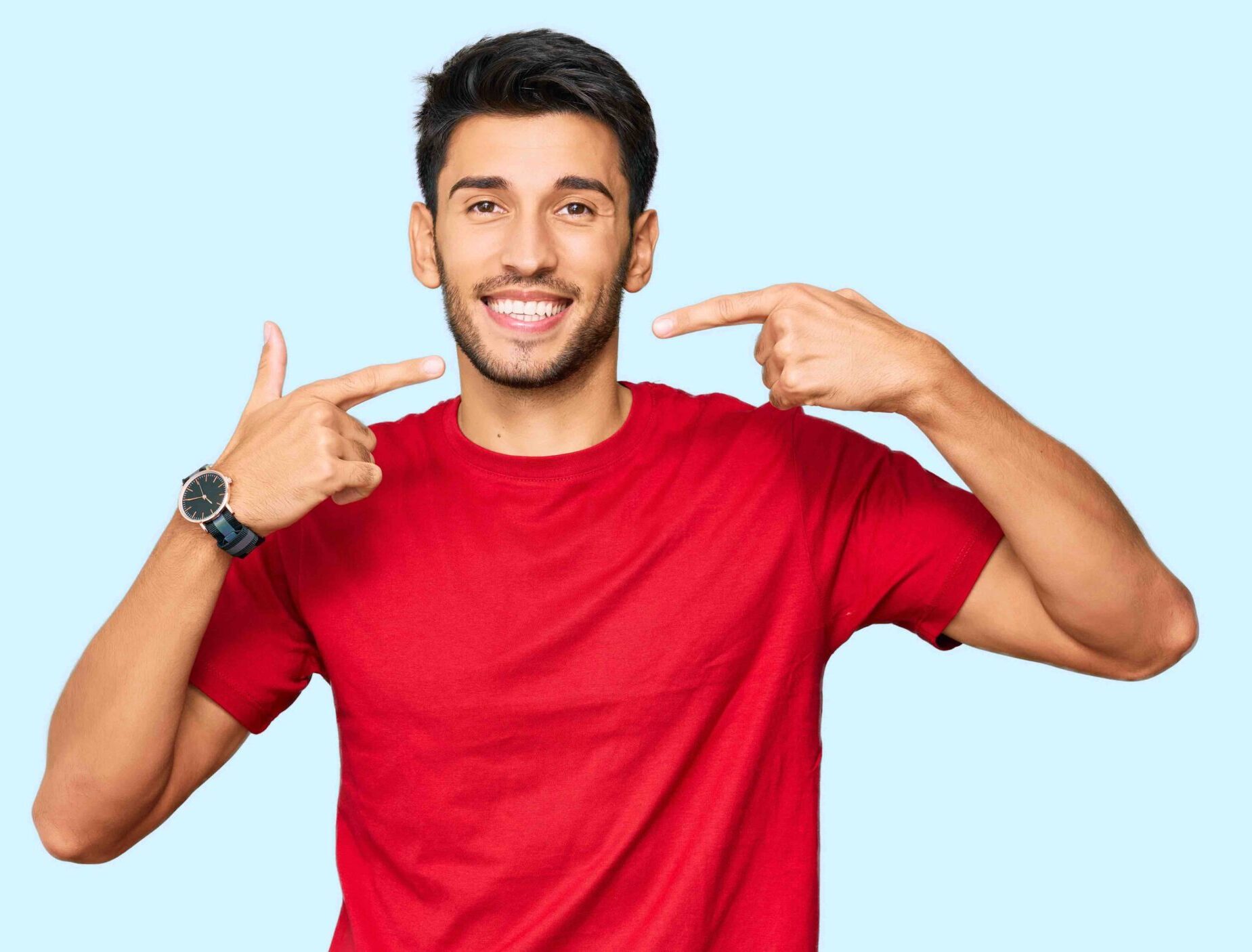 Young handsome man wearing casual red tshirt smiling cheerful showing and pointing with fingers teeth and mouth. dental health concept.
